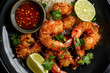 © kossovskiy - Spicy dipping sauce, lime, and crispy coconut shrimp