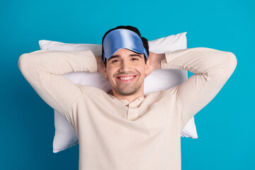 Sticker - Photo portrait of attractive young man lying pillow hands behind head dressed pajama sleepover good night isolated on blue color background