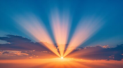 Poster - Brilliant rays of the setting sun illuminating a dramatic sky with gradient colors from deep blue to fiery orange,