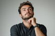 © Rizka - Portrait of a thoughtful man looking up with hand on chin