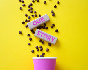 Our story symbol. Wooden blocks with words Our story Beautiful yellow background with coffee cup and coffee beans. Business and Our story concept. Copy space.