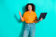 © deagreez - Photo of smart clever woman with wavy hairstyle dressed shirt hold laptop indicating empty space isolated on turquoise color background