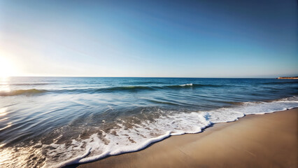 A tranquil beach scene with gentle waves and a clear blue sky