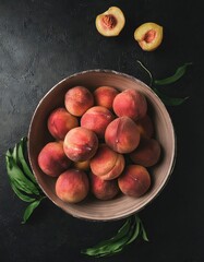 Wall Mural - peach in a bowl on a black background, top view, copy space