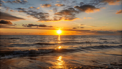 Wall Mural - A beautiful sunset over a calm ocean with the sun dipping below the Horizon