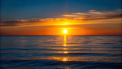 Wall Mural - A beautiful sunset over a calm ocean with the sun dipping below the Horizon