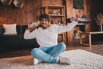 Sticker - Photo of cheerful positive guy dressed white pullover headphones enjoying songs modern gadget indoors house apartment room