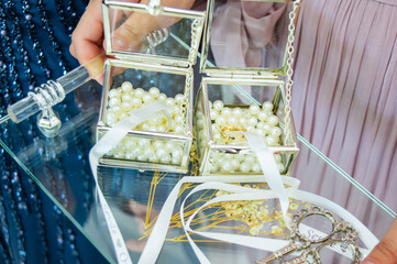 Engagement ring tray, white engagement ribbon tied to rings and antique scissors to cut it.