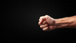 © koi_005 (Jiranan) - A close-up image of a clenched fist against a dark background, emphasizing strength, determination, and power. The detailed focus on the hand highlights the tension in the muscles