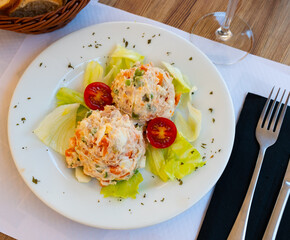 Wall Mural - Appetizing spanish olivier salad served on plate with fresh vegetables