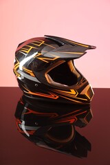 Canvas Print - Modern motorcycle helmet with visor on mirror surface against pink background