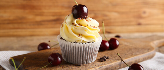 Sticker - Board with sweet cherry cupcake and berries on wooden background