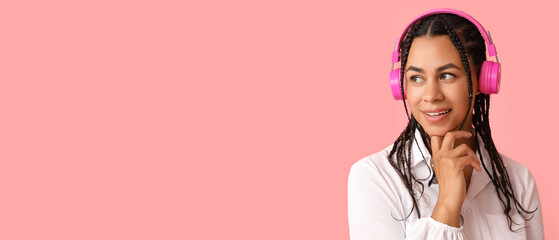 Poster - Beautiful African-American woman listening to music on pink background with space for text