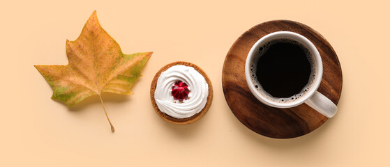 Cup of aromatic coffee, tasty cake and autumn leaf on color background