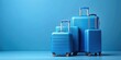 © Udomner - Blue suitcases on blue background, blue, suitcases, travel, luggage, blue background, vacation, storage, baggage