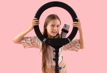 Poster - Teenage blogger with mobile phone and ring light on pink background