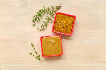 Wall Mural - Bowls with different mustard on wooden background