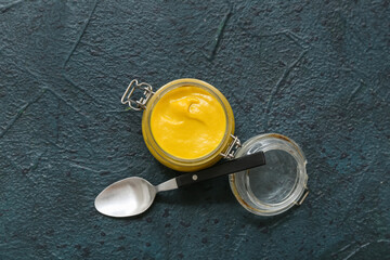 Sticker - Jar with creamy mustard and spoon on black grunge background