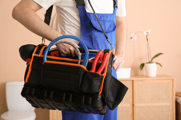 Poster - Male plumber with tool bag in bathroom, closeup