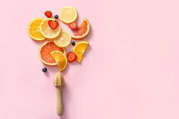 Canvas Print - Sliced citrus fruits, berries and juicer on pink background