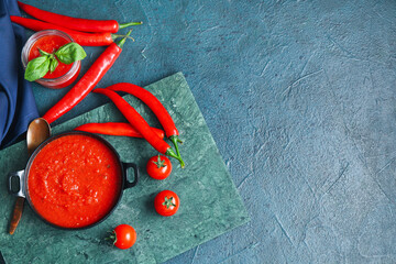 Poster - Frying pan and jar of tomato sauce with basil and chili peppers on dark background