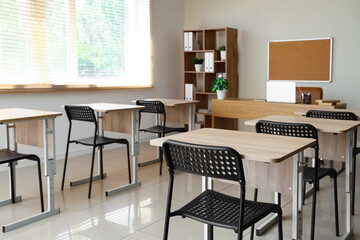 Poster - Interior of empty classroom with desks and chairs at school