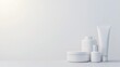 © Mnt - Minimalist display of white cosmetic containers on a clean surface, ideal for beauty product presentations and branding.