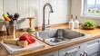 © PloyJai - Kitchen counter with a clogged sink, plunger, and plumber's accessories