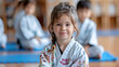 © Mahemud - Children in kimonos sitting on tatami mats during a martial arts seminar, with selective focus.