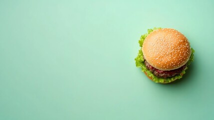 Wall Mural - Delicious Hamburger on a Green Background