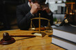 © aekachai - Male lawyer sitting and working, solving problems and work related to the legal work of lawyers.