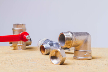 A water tap and a hose in a metal braid. Accessories for the repair of water supply.