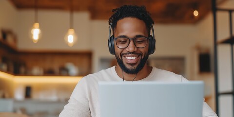 Wall Mural - An African American man working from home with their laptop on a call with a Team or client