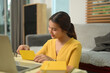 © Prathankarnpap - Young asian woman counting coins on table, saving or budgeting. Financial responsibility concept