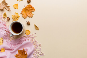 Wall Mural - flat lay composition with colorful autumn cup of coffee and leaves on a color background. top view