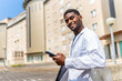 © unai - African doctor in a work break outside the hospital