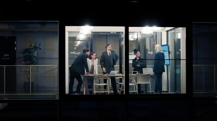 Poster - Portrait of a Group of Corporate Workers Analyzing Results From a Business Report. Managers Looking at Data on Screen, Employees Having a Conversation in a Meeting Room. View from Outside the Window