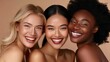 © liliyabatyrova - Three diverse models wearing natural makeup share joyful smiles in a softly lit studio. Their genuine expressions highlight unity and friendship among different cultures