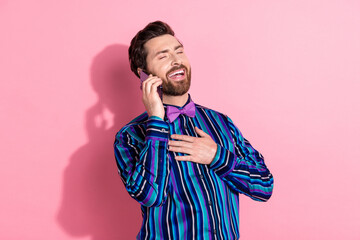 Canvas Print - Photo of positive elegant man wear trendy striped clothes hold gadget isolated on pink color background