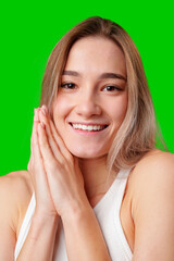 Sticker - Smiling Woman With Blonde Hair Holding Hands to Face Against Green Screen