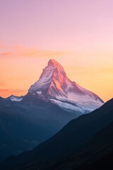 The peak of a distant mountain framed against a sunset sky