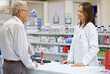 © ArcursForPI/peopleimages.com - Woman, pharmacist and senior man at counter for consultation, medicine prescription and healthcare advice. Medical worker, elderly customer and discussion of product help, assitance and pharmacy care