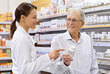 © ArcursForPI/peopleimages.com - Woman, pharmacist and senior man with pills for prescription, product information and healthcare advice. Medical, customer and medicine dispensary with instructions, pharmaceutical care and treatment