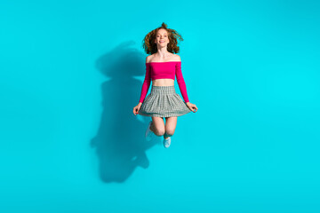 Wall Mural - Full size photo of pretty young girl jump wear top isolated on teal color background