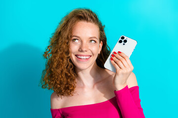 Wall Mural - Portrait of lovely young girl smart phone look empty space wear pink top isolated on turquoise color background