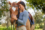 Rider, woman and bonding with horse outdoor in forest for companion, training and relax from practice. Equestrian, person and stallion in countryside with embrace, smile and hug animal in nature