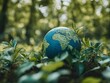 © Mikki Orso - Earth globe encircled by green leaves  symbol of nature conservation and global sustainability