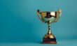 © Farid - gold winner cup on blue background.
