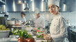 © Alina Tymofieieva - Chef stands confidently in a modern kitchen with colleagues preparing dishes during a busy service