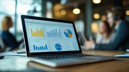 Leinwandbilder - The image portrays a modern office environment with professionals in a meeting. The laptop displaying various data charts and graphs is the main focus of the image.
